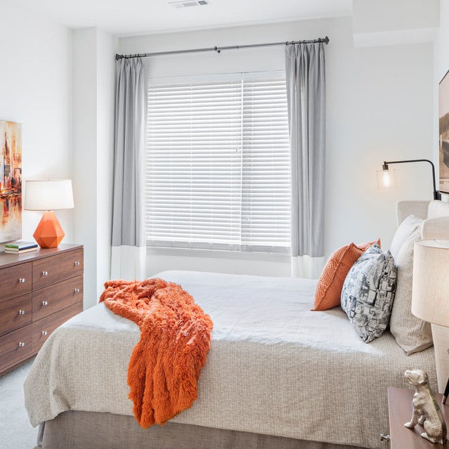 Fuse Cambridge Apartments - spacious bedroom with carpet flooring and large window