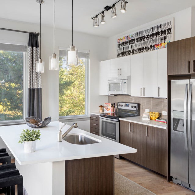 Fuse Cambridge Apartments - kitchen with stainless steel appliances, two-tone cabinetry, and kitchen island