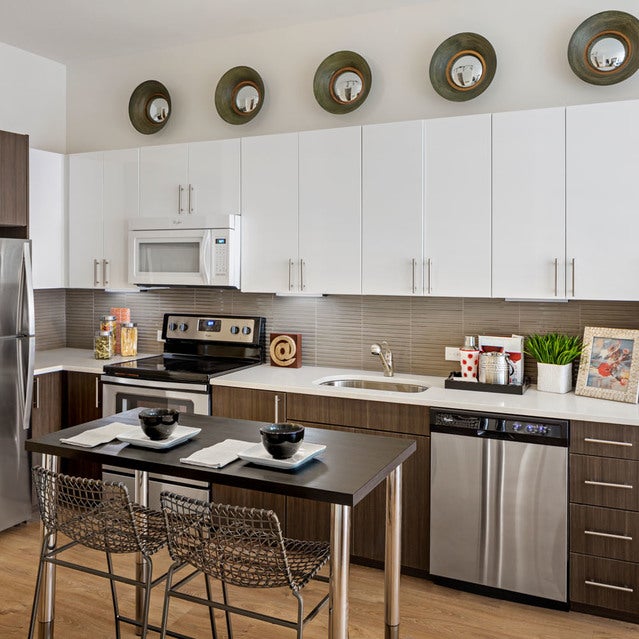 Fuse Cambridge Apartments - kitchen with stainless steel appliances, two-tone cabinetry, and white countertops