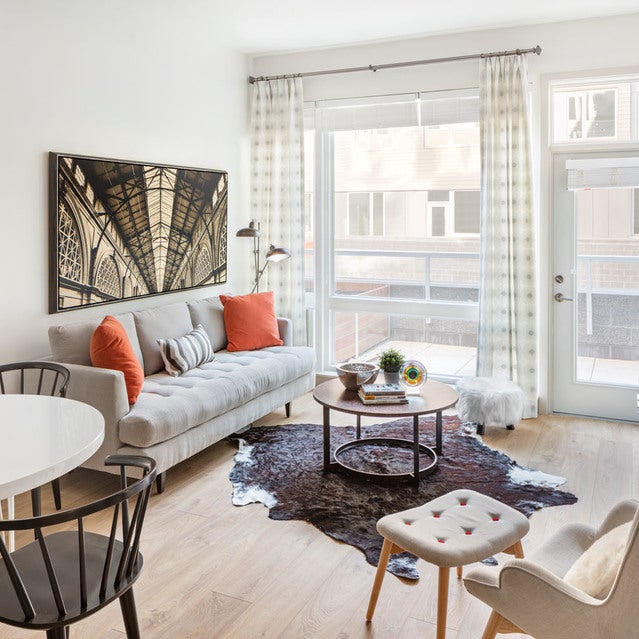 Fuse Cambridge Apartments - living room with hardwood flooring and large windows overlooking private patio