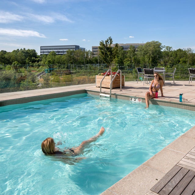 Fuse Cambridge Apartments - resort style pool with mosaic tile terrace and surrounding tables and lounge chairs